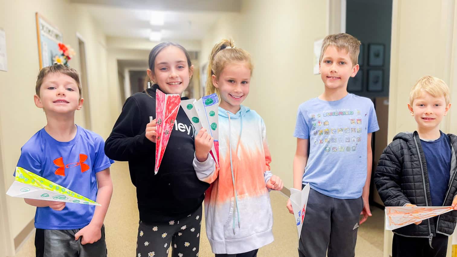 students-holding-paper-airplanes